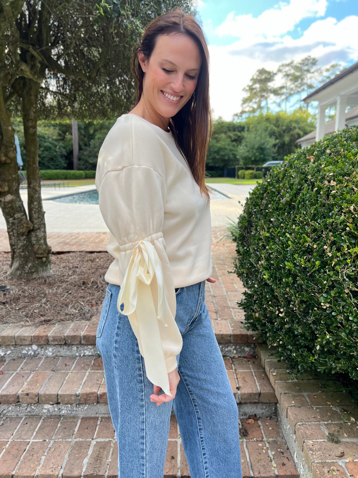 Onto the Next Cream Bow Sweatshirt