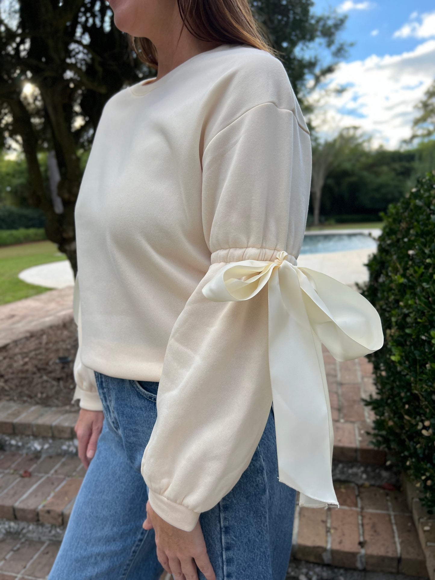 Onto the Next Cream Bow Sweatshirt