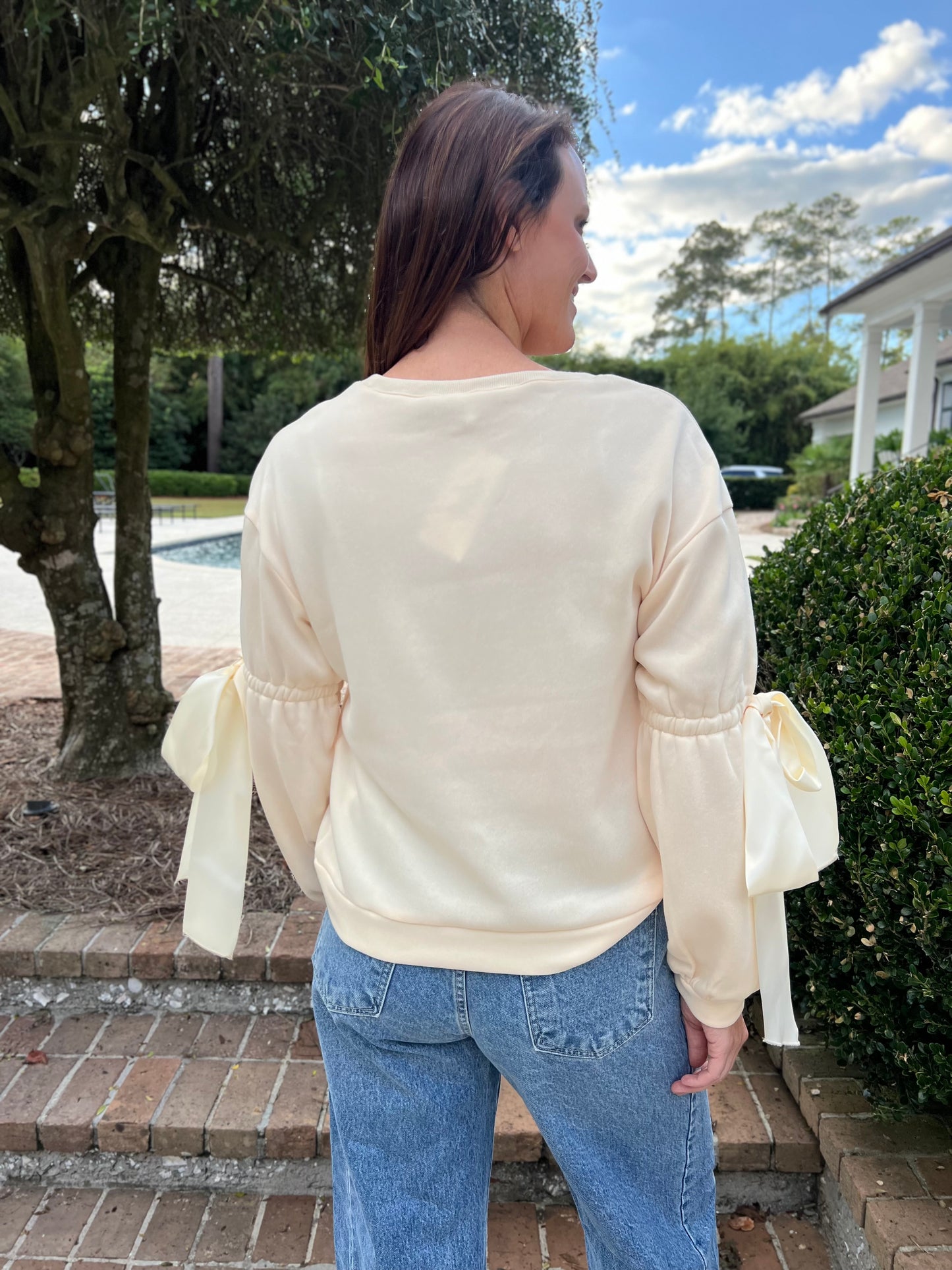 Onto the Next Cream Bow Sweatshirt