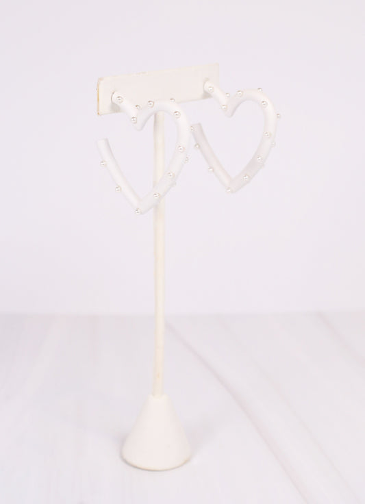 This coated metal heart earring is adorable! It is studded with pearl accents on a post back.  Dimensions: 2" diameter